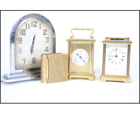 A collection of four 20th century clocks to include an Art Deco chrome mantle clock, two brass carriage clocks and a travel c