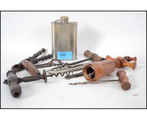 A collection of corkscrews circa 19th and 20th century together with old nutcrackers, bottle cap pull and a white metal hip f