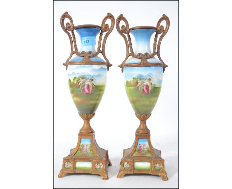 A pair of 19th century gilt metal and ceramic Sevres manner twin handled vases. Each with gilt metal rococo embellishments ha