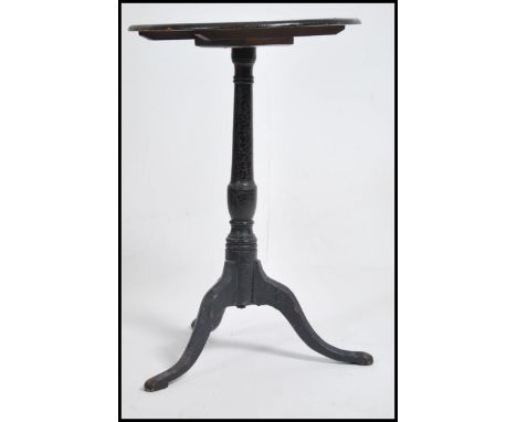 A 19th century Georgian scrumble finished tripod wine table being raised on splayed legs with turned column having circular t