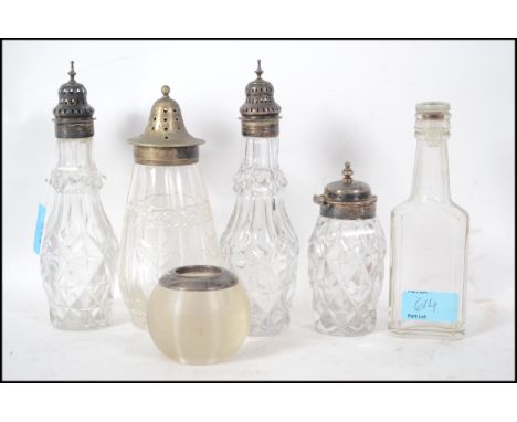 Group of four pieces of cut glass ware, three having hallmarked silver tops and one plated but well worn along with a turned 