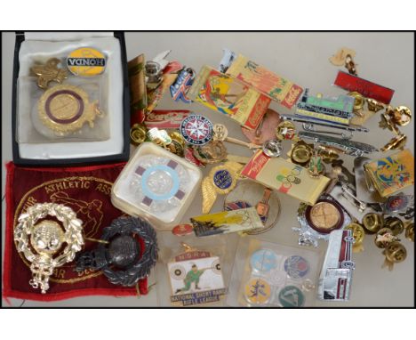 A collection of enamel badges dating to the 20th century  to include motor cars, National Short Range Rifle, Coca-Cola, Junio