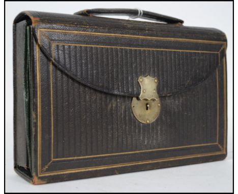 A 19th century leather tooled cased travelling writing stationary set. Opening to reveal sectional compartments, Ivory and mo