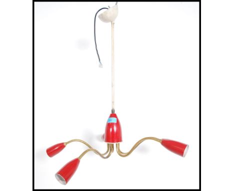 A stunning atomic five point ceiling light fixture having a central conical red rose with five satellite brass branches each 