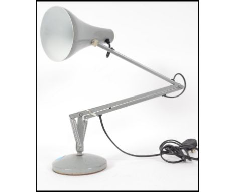 A retro 20th century industrial  Herbert Terry angle poise desk lamp raised on a circular base fitted with a conical shade. O