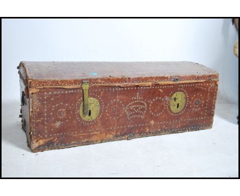 A Georgian style leather covered domed trunk with studded details. The top initialed with further studding and  carrying hand