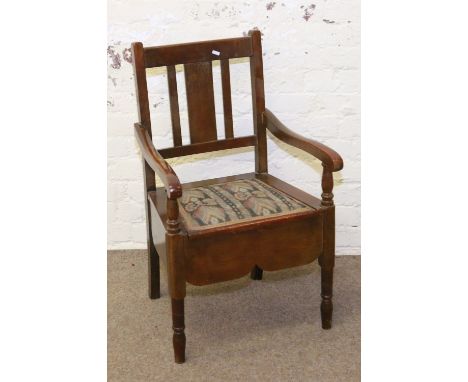 An Edwardian commode armchair with later alteration to underseat.