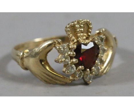 A 9ct gold Claddagh ring set with a garnet and white paste stones, size K 1/2.