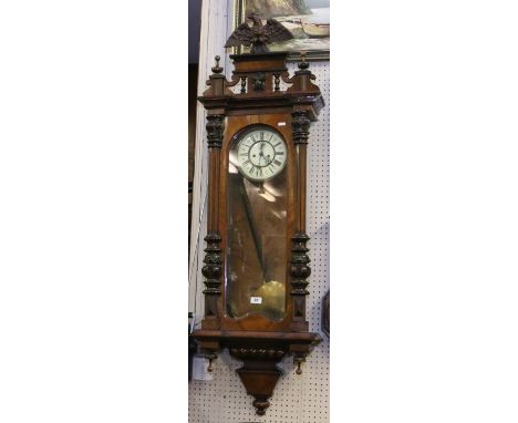 A C19th walnut cased twin weight Vienna wall clock with eagle finial, subsidiary seconds and chiming half hourly on a gong (A