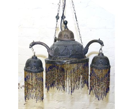 An Art Nouveau pierced copper three branch ceiling light with beadwork fringing.