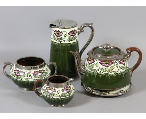 A Gibson pottery Art Nouveau tea service decorated with stylized poppies.