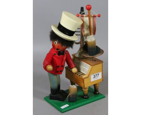 A Steinbach clockwork musical incense smoker formed as a man playing a piano and holding a stein.