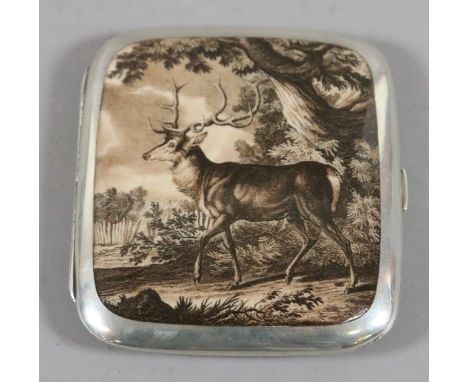 A Continental silver and enamel cigarette case with gilt interior and decorated in monochrome with a stag emerging from a woo