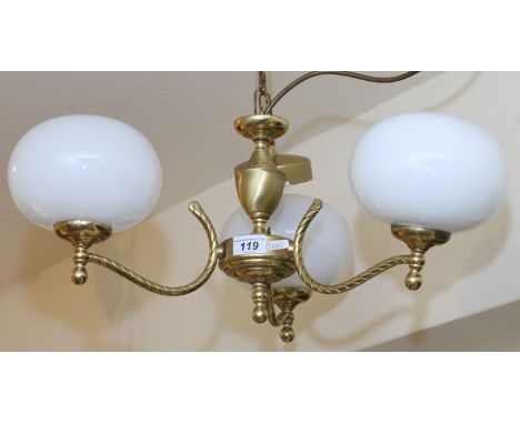 A brass ceiling light with three globular lights.