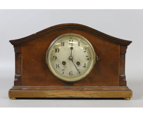 An Edwardian inlaid mahogany mantel clock housing a French eight day movement.