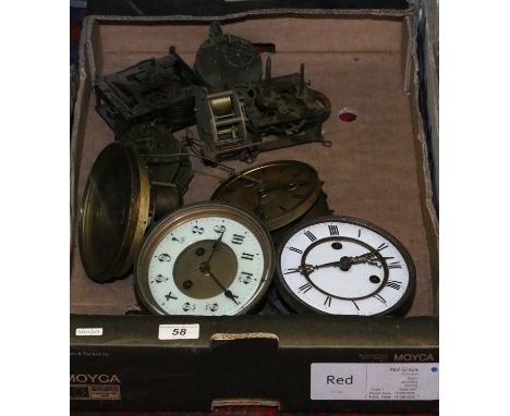 A box of clock movements and dials.
