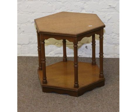 A light oak two tier hexagonal lamp table raised on turned supports.