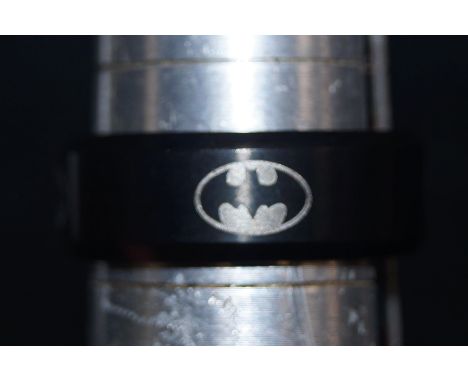 Black titanium ring, depicting the batman symbol. Size- V