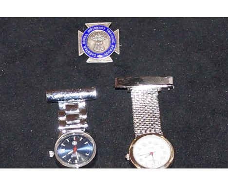 Two nurses fob watches with related silver enamel badge