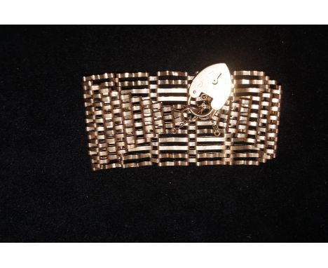 9ct Gold, gate bracelet with heart locket and safety chain. Weighs- 23g