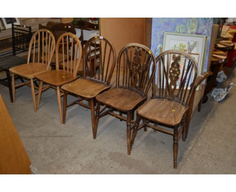 A pair of stick and wheelback elm seated chairs; one other stick back chair; and a pair of Ercol type stick back chairs 