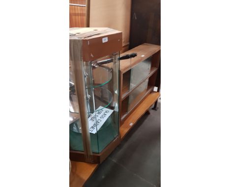 A glass display cabinet, a rustic bench/ coffee table and minty bookcase with glass sliding doors 