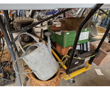 A mixed lot garden items including terracotta pots, metal watering cans, cast iron hopper, decorative items, tools, garden tr