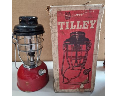 A red tilley lamp in original box. 