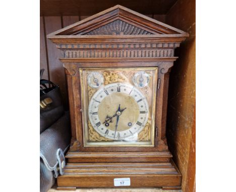 A oak architectural bracket clock with pendulum and key 