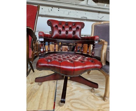 An oxblood red leather Chesterfield captain's chair. Condition- good overall, only very light signs of use/wear.