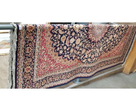 An Eastern Keshan style carpet, blue ground with floral design, 240cm x 160cm (approx). 