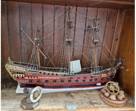 A model of a 4th Class Man-o-war c1690, made by W R Campbell, together with 2 nutcrackers in the form of ships wheels.Conditi