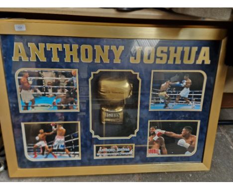 An Anthony Joshua signed glove and light up picture display.Note:- Light on glove flickers.