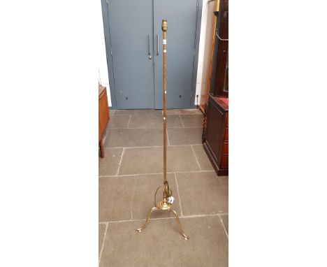A vintage brass tripod standard lamp. 
