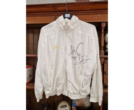 A shell suit jacket signed by Steffi Graf. 