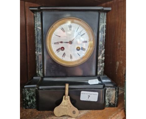 A black slate mantle clock. 