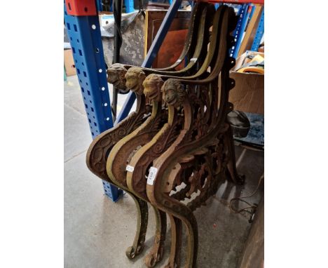 Four cast iron bench ends. 