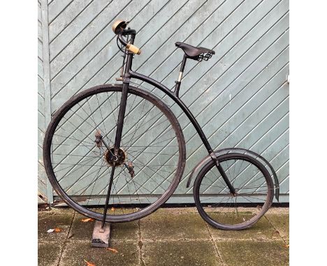 An early 20th century black enamelled Penny Farthing, front wheel 33" &amp; back wheel 19" diameter, complete with Dunlop tyr