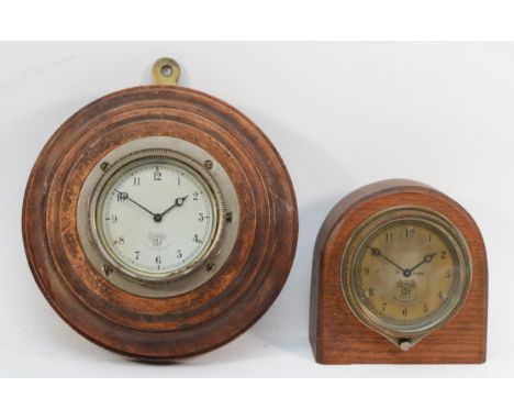 An early 20th century Smiths of London oak cased dome topped car dashboard clock, the dial with black highlighted Arabic nume