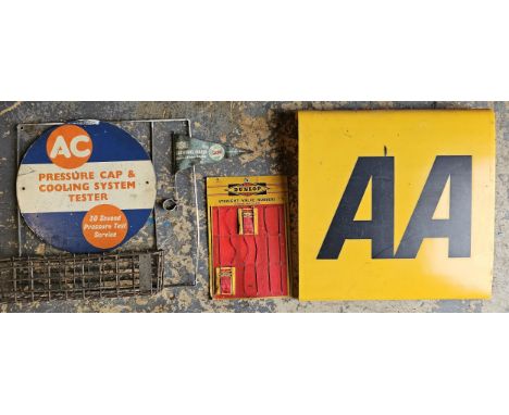 A Dunlop Straight Valve Rubbers display board, 26 1/2 x 18cm, an AC display, an AA perspex sign and a NSU Fally 1958 flag (4)