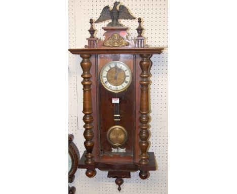 An early 20th century walnut Vienna type drop trunk wall clock