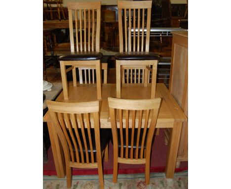 A contemporary light oak dining suite comprising; extending dining table having pull-out action and two extra drop-in leaves,