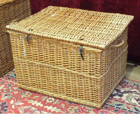 A large wicker hamper, possibly a log basket, 68cm wide.