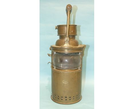 A Bulpitt &amp; Sons brass marine signalling lamp with wood handle and clear bulb eye glass, (chipped), oval trade mark, 42cm