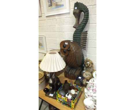 A modern carved wood model of an owl, 51cm high, a carved wooden hare table lamp and other animal figures.