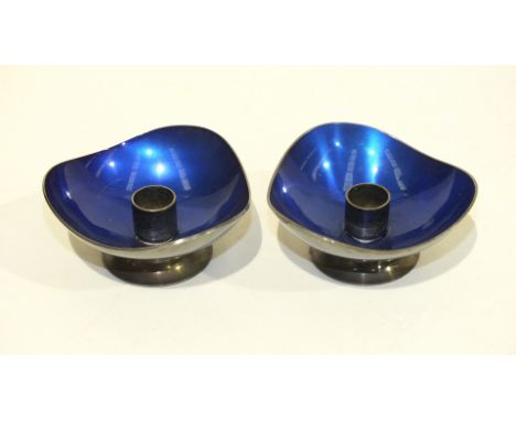 A pair of Meka, Denmark, blue enamel and white metal taper holders, 3cm high, 6cm wide, (2).