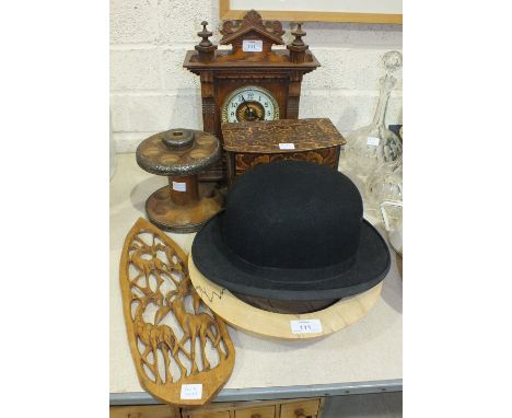 An oak-cased striking mantel clock, 34cm high, a circular metal-mounted wooden two-tier egg holder with concealed egg timer, 