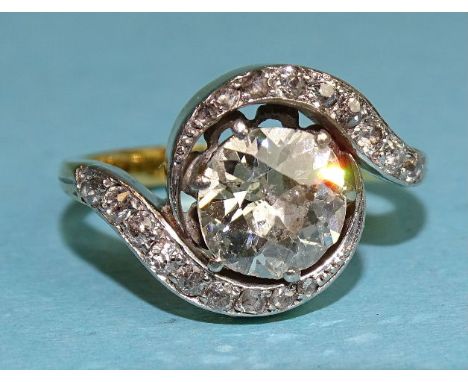 A solitaire diamond ring claw-set an old brilliant-cut diamond of approximately 1.25cts, in unmarked gold crossover setting s