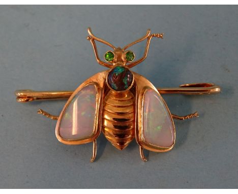 A 20th century yellow gold bee brooch with black opal-set thorax, water opal wings and carved gold abdomen, mounted on gold p