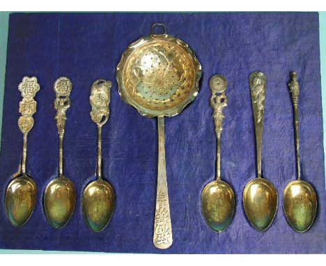 A collection of six harlequin Chinese silver teaspoons and a tea strainer, in fitted box. 